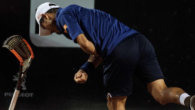 Japan's Kei Nishikori smashes his racquet.