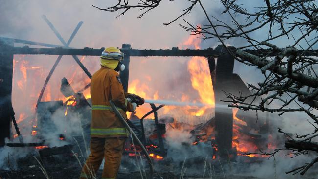 Firefighters work to extinguish the blaze. Picture: DAMIAN BESTER