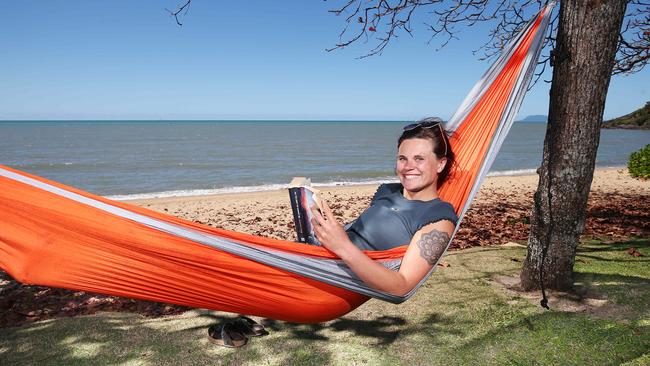 Tasmanian tourist Noona Auderset made the most of the balmy temperature by lazing about in a hammock at Trinity Beach. Picture: Brendan Radke