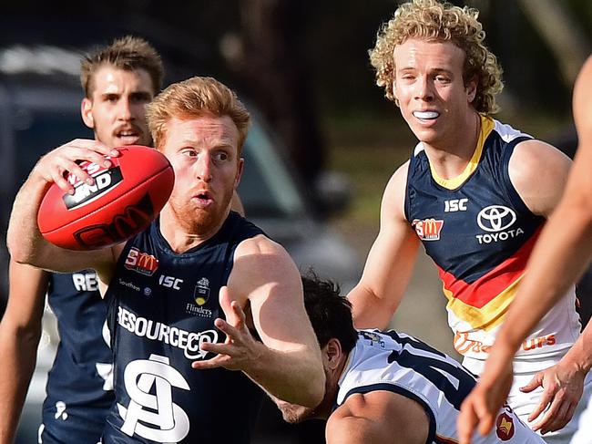 17/06/18 - South Adelaide v Adelaide Crows SANFL match at Hickinbotham Oval, Noarlunga.  South's Nicholas Liddle breaks a tackle from Adelaide's Ben Jarman. Picture: Tom Huntley