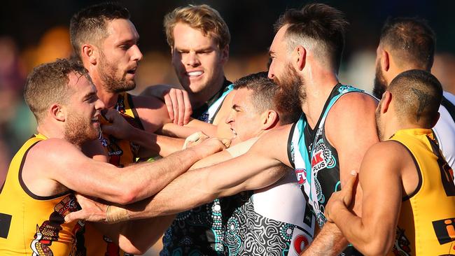 Hawthorn’s Tom Mitchell wrestles with Port Adelaide opponents last week. Picture: Getty Images