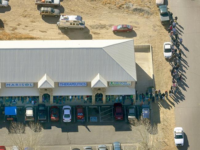 A long line of buyers trails from a store selling marijuana in Pueblo West, Colorado.