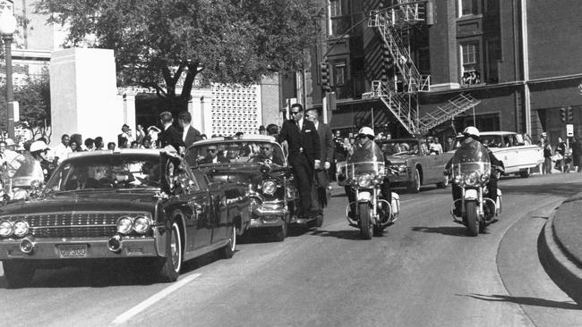 John F. Kennedy's motorcade passes the Texas School Book Depository prior to the assassination on November 22, 1963 in Dallas, Texas. Picture: Corbis