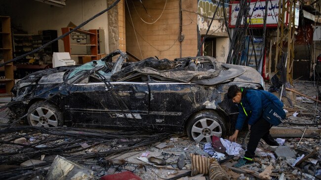 Possessions litter the street next to a destroyed car after Tyre came under missile attack. Picture: Oliver Marsden/The Times