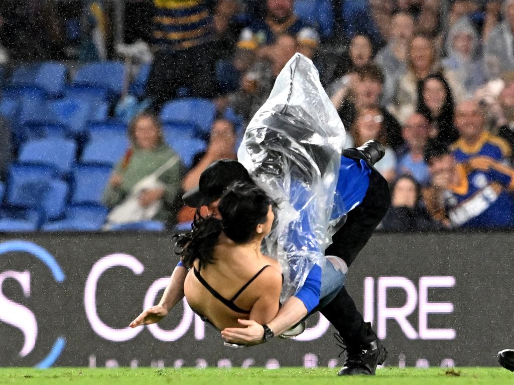 Javon Johanson is ironed out by a security guard. Picture: Bradley Kanaris/Getty