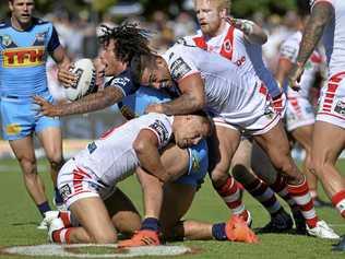 TACKLED: Gold Coast Titans prop Kevin Proctor is wrapped up by the Dragons defence. Picture: Kevin Farmer