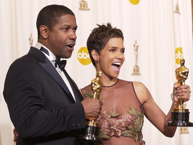 Denzel Washington and Halle Berry show off their Oscars for best actor and actress in 2002.