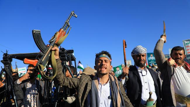 Armed Yemenis chant slogans during a march in solidarity with the people of Gaza.