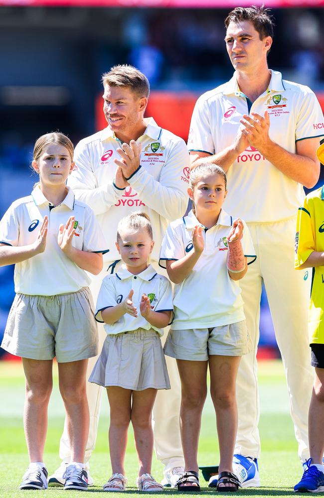 David Warner, in his farewell Test last summer, stands alongside his three daughters as well as captain Pat Cummins. Picture: Getty