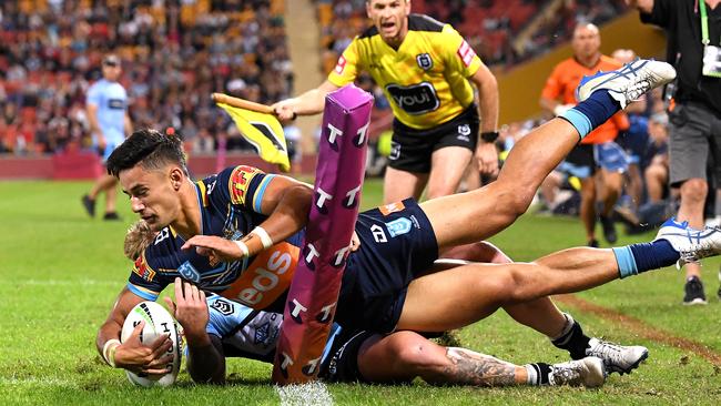 Jesse Arthars is taken over the sideline by some desperate Sharks defence.