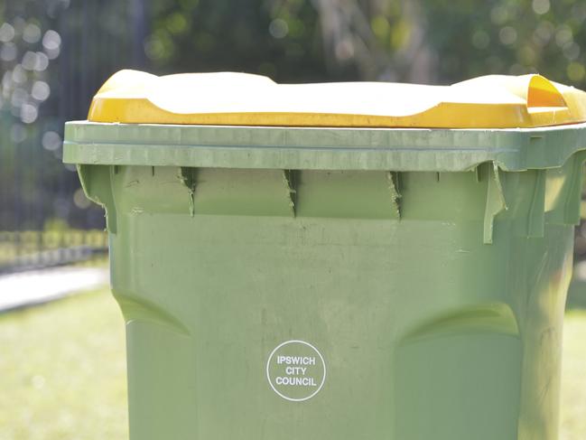 A yellow recycling bin.