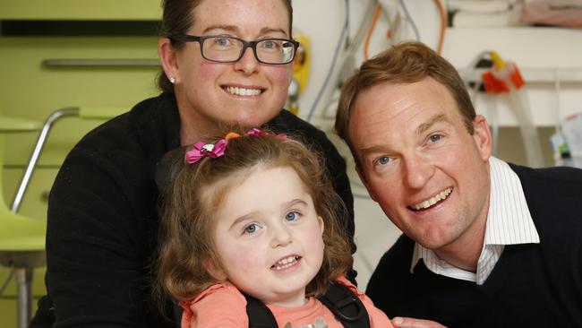 Parents Amanda Hulands-Nave and Mark Nave with Stephanie before she goes into theatre to receive her first dose of Spinraza at the RCH. Picture: David Caird