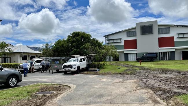 Minister for Education John-Paul Langbroek arriving at disaster-impacted Ingham State High School on Wednesday. The school serves as the Hinchinbrook Evacuation Centre, pictured on the right. Picture: Cameron Bates