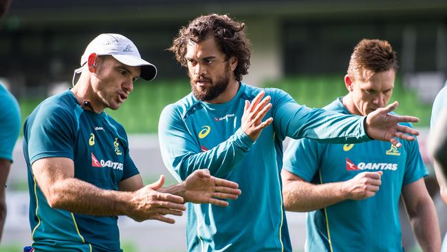 Assistant coach Nathan Grey works with Karmichael Hunt at Wallabies training.