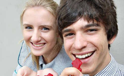 Matthew Flinders students Sophie Wright and Hamish Lawler with red frogs handed out by the Red Frogs crew ahead of Schoolies celebrations. Picture: Nicholas Falconer