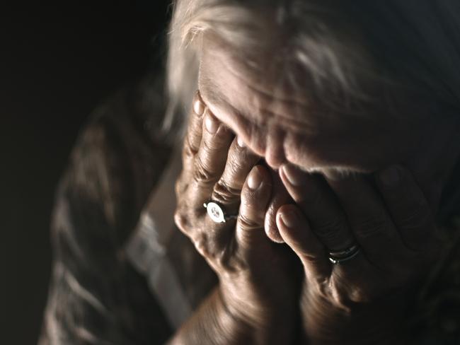 ISTOCK GENERIC -  Desperate senior crying in a dark room. Perfectly usable for a wide range of topics like depression, loneliness or mental health in general.