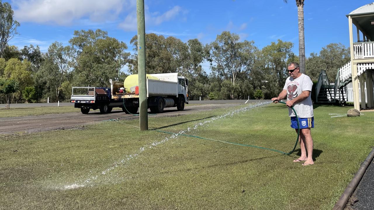 Scott Hornick cleans up his front yard after the Dalby floods, March 2022 Picture: Emily Devon