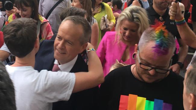Bill Shorten is embraced by a party goer in Melbourne. Picture: Simone Fox Koob.