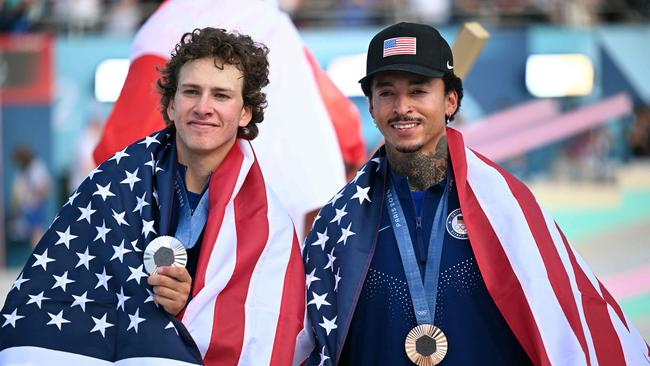 USA's Jagger Eaton (L) and bronze medallist Nyjah Huston pose with their medals after the victory ceremony for the men's street skateboarding event. (Photo by Kirill KUDRYAVTSEV / AFP)