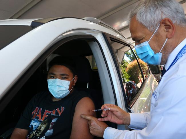 Dr Jamal Rifi administers the Pfizer at Belmore. He also runs a testing clinic vaccine and says his staff are exhausted. Picture: Getty Images