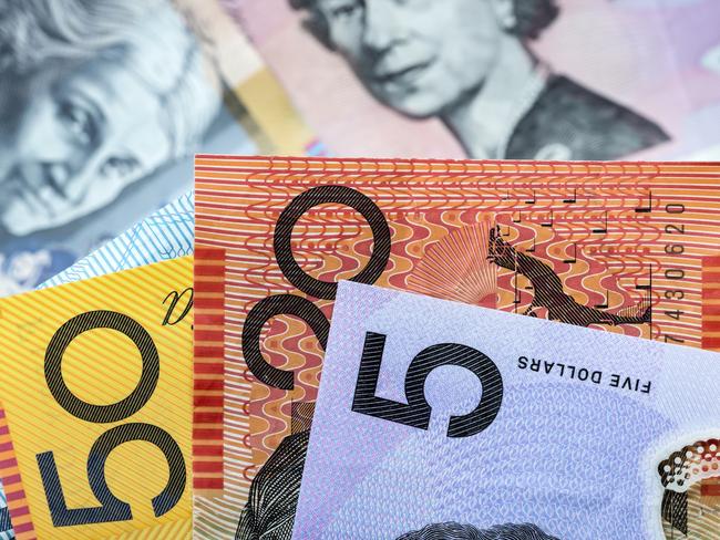 Australian money background.  Focus on foreground, blurred faces beneath. Notes generic