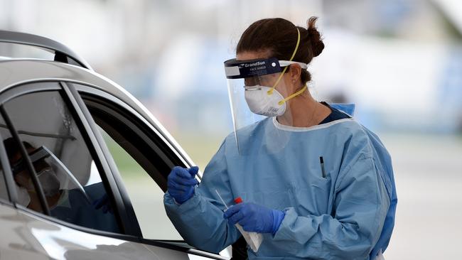 Testing times... A nurse prepares a COVID-19 test at the Bondi Beach drive-through clinic.