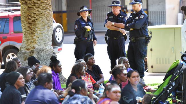 Police watch over relatives of Kumanjayi Walker gathered outside of Alice Springs Local Court on Thursday. Picture: AAP