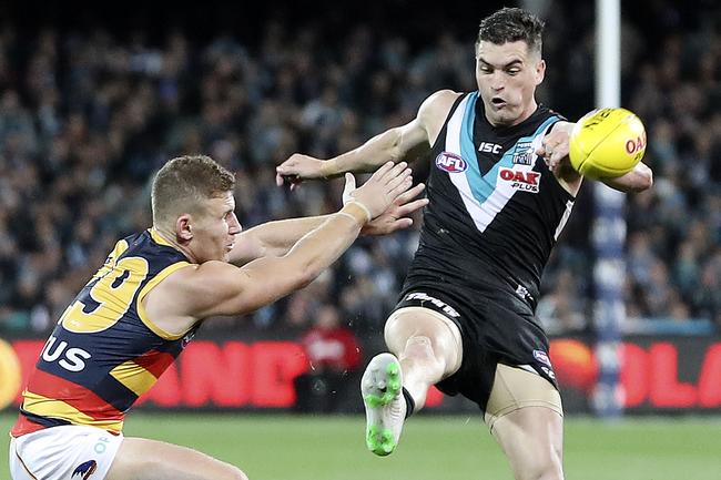 Adelaide’s Rory Laird attempts to smother Power’s Tom Rockliff in Showdown 46 at Adelaide Oval. Picture Sarah Reed