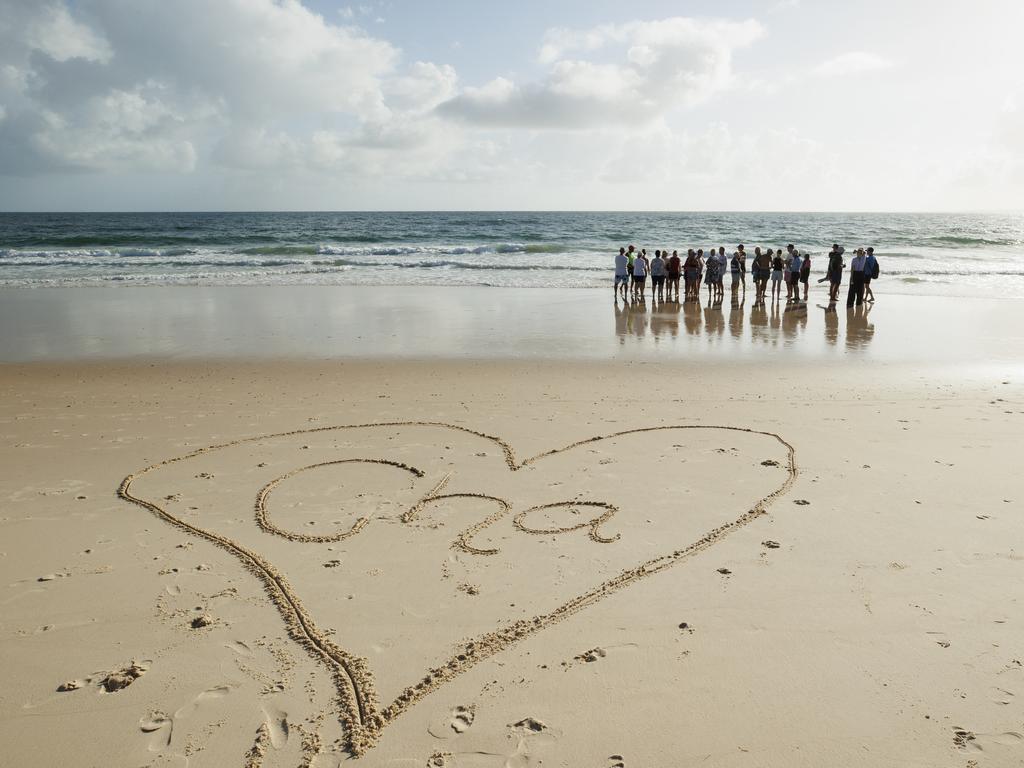 Bribie Island locals gather to pay tribute to 17 year old local Charlie Zmuda who was killed in a shark attack at Woorim Beach on Monday afternoon. Picture: Lachie Millard