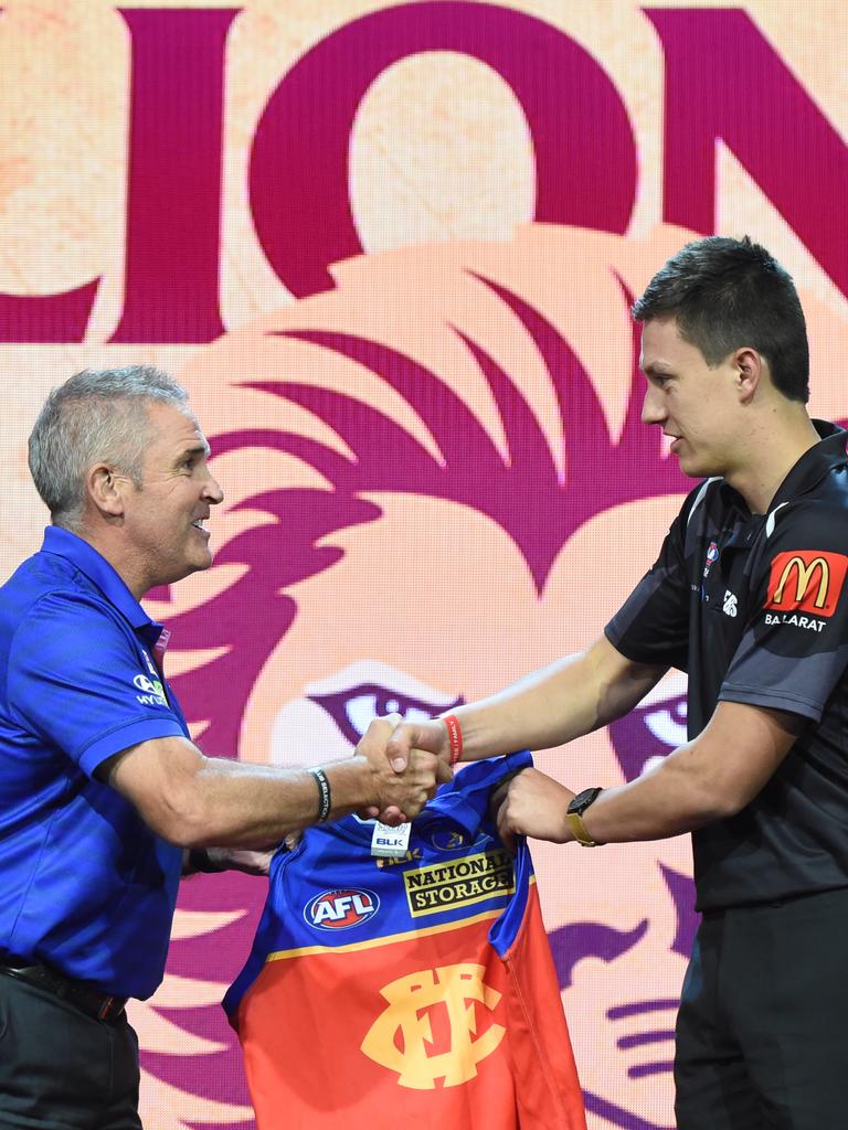 Hugh McCluggage (right) gets his Lions jumper from Chris Fagan at the draft.