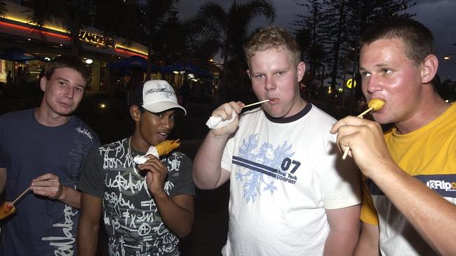 Dagwood dogs all round for Pete Hale, Nic Franciscus, Tim Voigt and Danny Johnson celebrate New Year’s Eve at Mooloolaba in 2003.