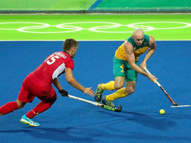 RIO DE JANEIRO, BRAZIL - AUGUST 09: Glenn Turner #4 of Australia moves the ball past Emmanuel Stockbroekx #15 of Belgium during the hockey game on Day 4 of the Rio 2016 Olympic Games at the Olympic Hockey Centre on August 9, 2016 in Rio de Janeiro, Brazil. (Photo by Christian Petersen/Getty Images)