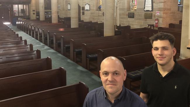 Minister David Ould with parishioner Marc Safari at St John's Anglican Cathedral, which will turn away crowds from Sunday.