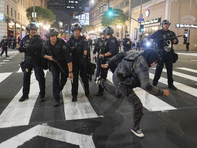 A protester runs as police officers move forward during a protest over the death of George Floyd in Los Angeles. Picture: AP