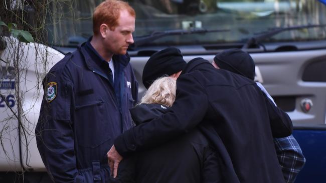 NSW Police Detectives comfort Mark and Faye Leveson, the parents of Matthew Leveson, after discovering something during excavation work as they continue to search bushland in the Royal National Park south of Sydney, Wednesday, May 31, 2017. Picture: AAP Image/Dean Lewins.