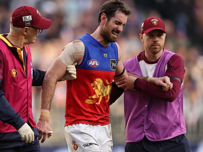 PERTH, AUSTRALIA - JUNE 05: Darcy Gardiner of the Lions is assisted from the field during the round 12 AFL match between the Fremantle Dockers and the Brisbane Lions at Optus Stadium on June 05, 2022 in Perth, Australia. (Photo by Paul Kane/Getty Images)