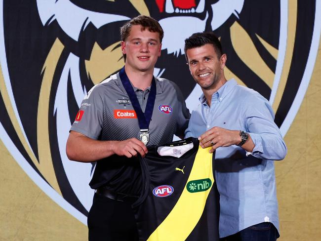 MELBOURNE, AUSTRALIA - NOVEMBER 20: The number one pick, Sam Lalor is presented his jumper by Trent Cotchin during the 2024 Telstra AFL Draft at Marvel Stadium on November 20, 2024 in Melbourne, Australia. (Photo by Michael Willson/AFL Photos via Getty Images)