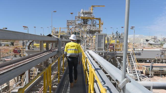 A worker walks across a bridge at the processing plant of the Pilbara Minerals Ltd. Pilgangoora lithium project at Port Hedland, Western Australia. Picture: Bloomberg