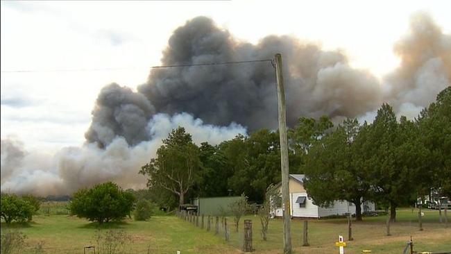 The fire is closing in on homes near Newcastle Airport.