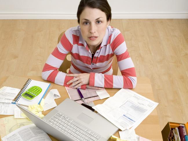 MORTGAGE STRESS .. Woman with laptop and paperwork