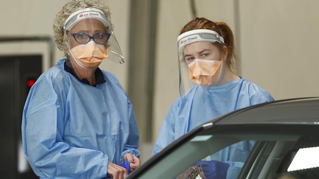 Health workers carry out Covid tests at a drive-through testing site at Albert Park Lake on Monday. Picture: Darrian Traynor/Getty Images