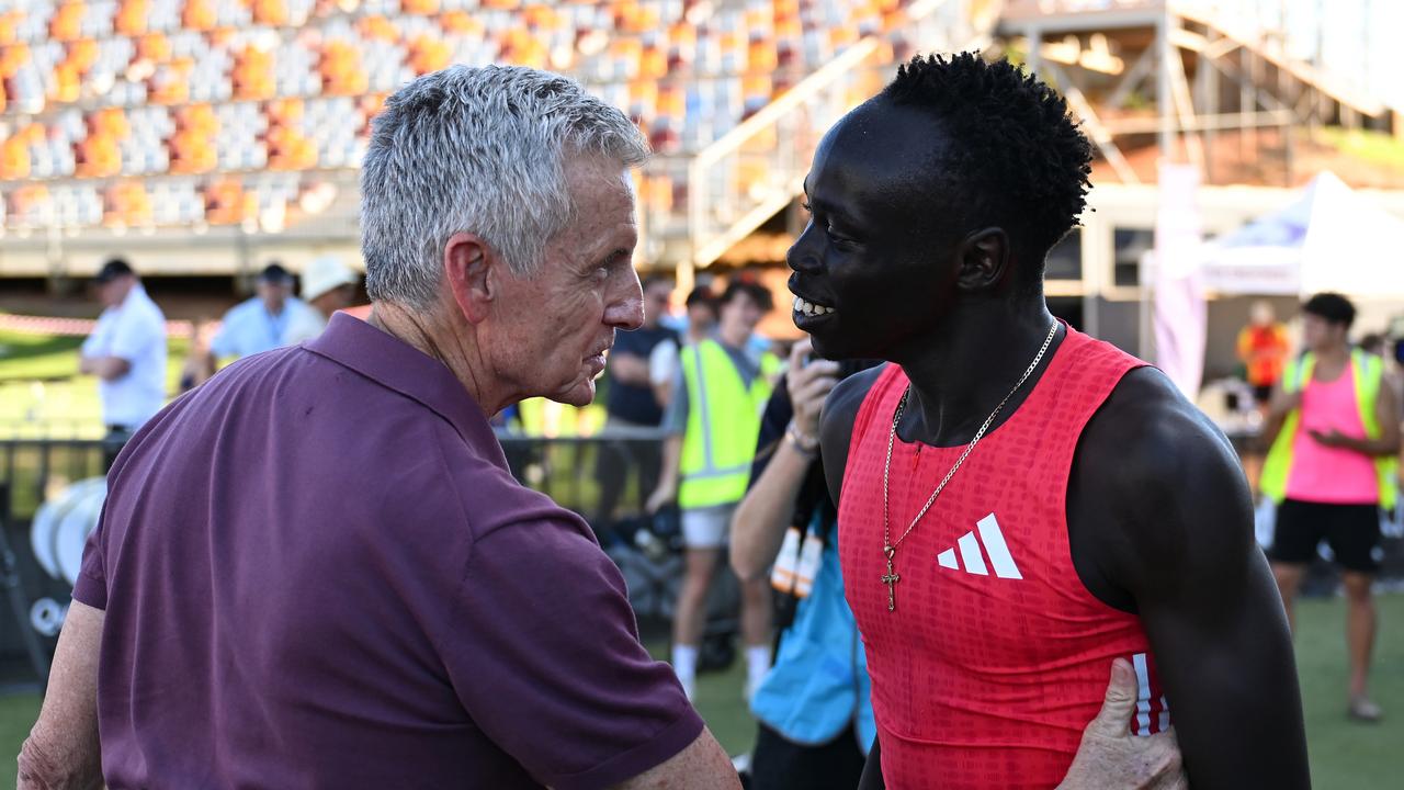 Bruce McAvaney and Gout Gout embrace after Gout Gout won the Men 200m Under 20 Final during the Queensland Athletics Championships. (Photo by Albert Perez/Getty Images)