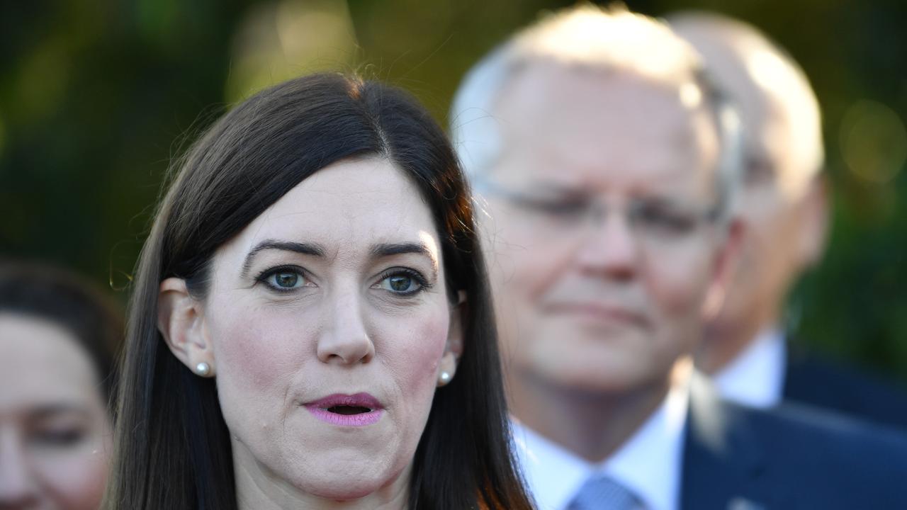 Liberal Member for Boothby Nicolle Flint with Prime Minister Scott Morrison in the background. Picture: David Mariuz/AAP