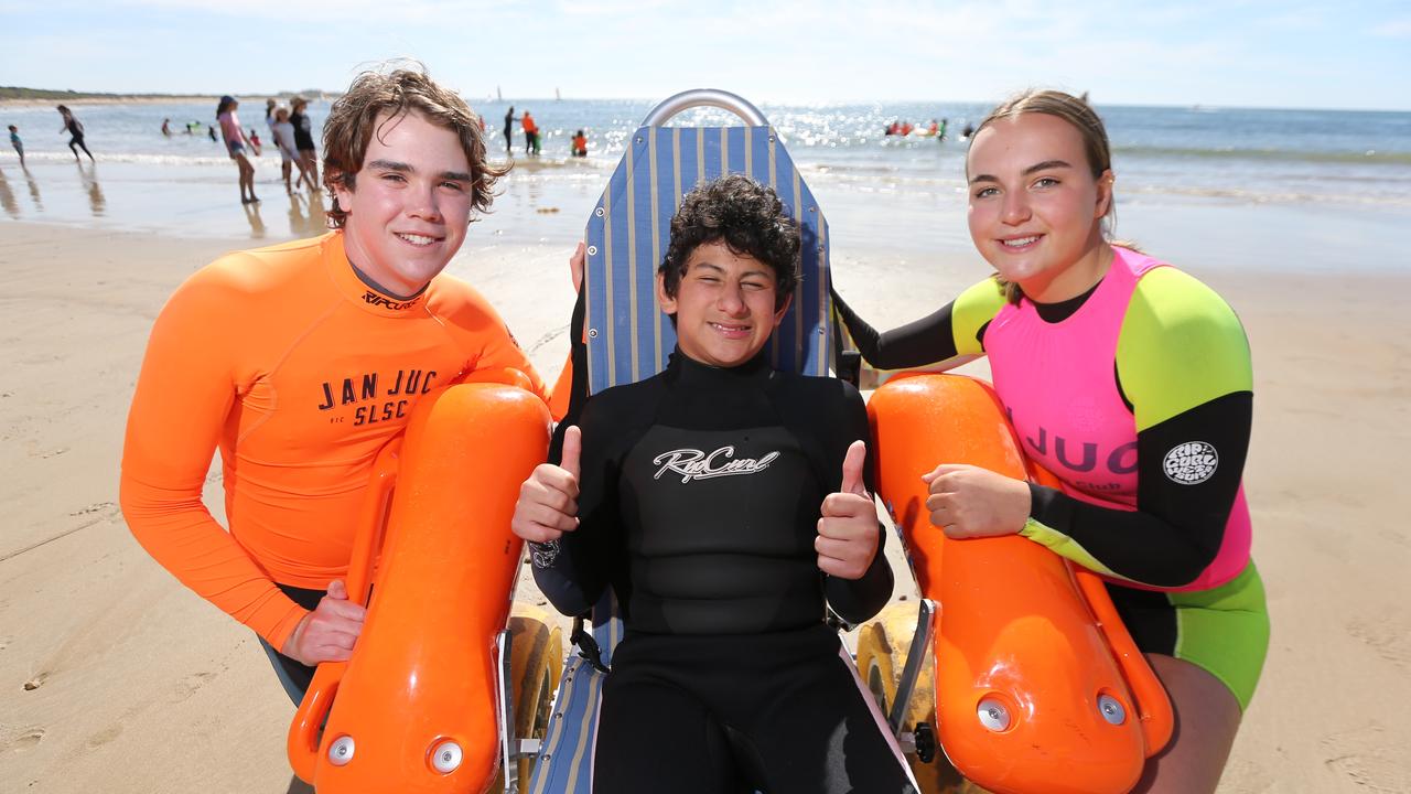 Jan Juc Surf Lifesaving Club volunteers Samuel Dripps and Lulu Higgins with Tjay Curtis at Torquay about to hit the waves for Kids Plus Foundation Surf Ed Program.Picture: Peter Ristevski