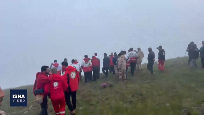 Rescuers walk towards the crash site. Picture: X