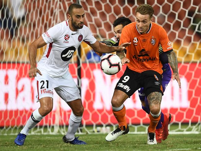 Vedran Janjetovic and Tarek Elrich of the Wanderers and Adam Taggart of the Roar contest the ball. 