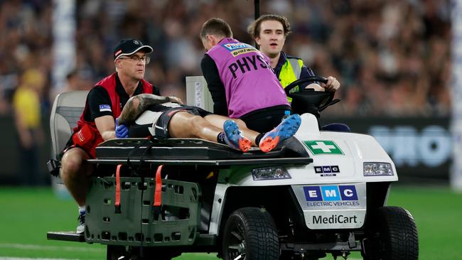 Jeremy Howe of the Magpies leaves the field on a stretcher. Picture: Dylan Burns