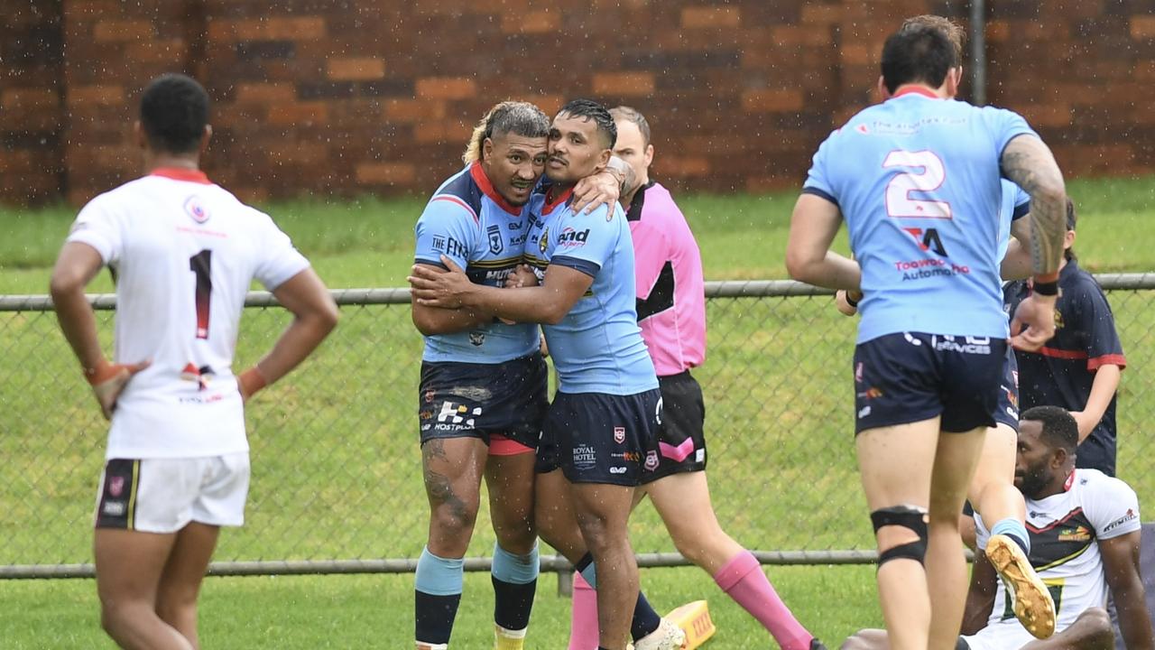 Western Clydesdales Bessie Toomaga and Cory Mcgrady celebrate Toomaga’s try against the PNG Hunters.