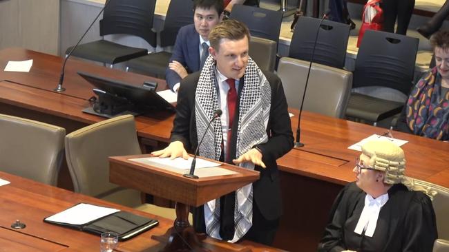 Keffiyeh-draped NSW Young Lawyers secretary Seth Harlen gives his admissions address to the NSW Supreme Court.