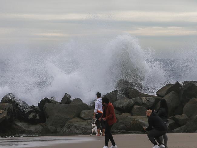 People observe big waves in the breakwater in Venice Beach, Los Angeles, after an undersea volcano erupted in the Pacific Ocean near Tonga. Picture: Apu Gomes/Getty Images/AFP